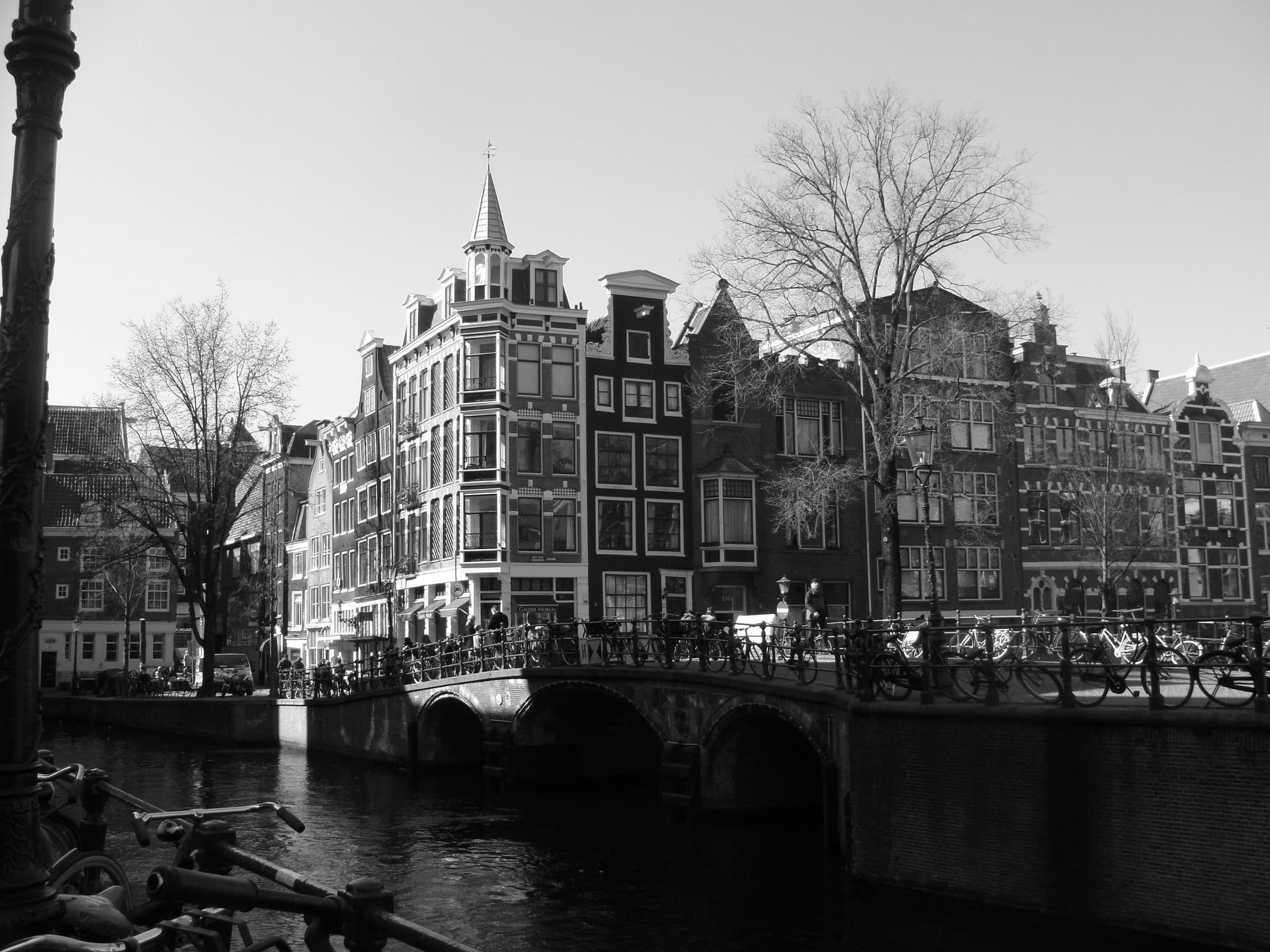 Black and white image of amterdam buildings depicting history of amsterdam