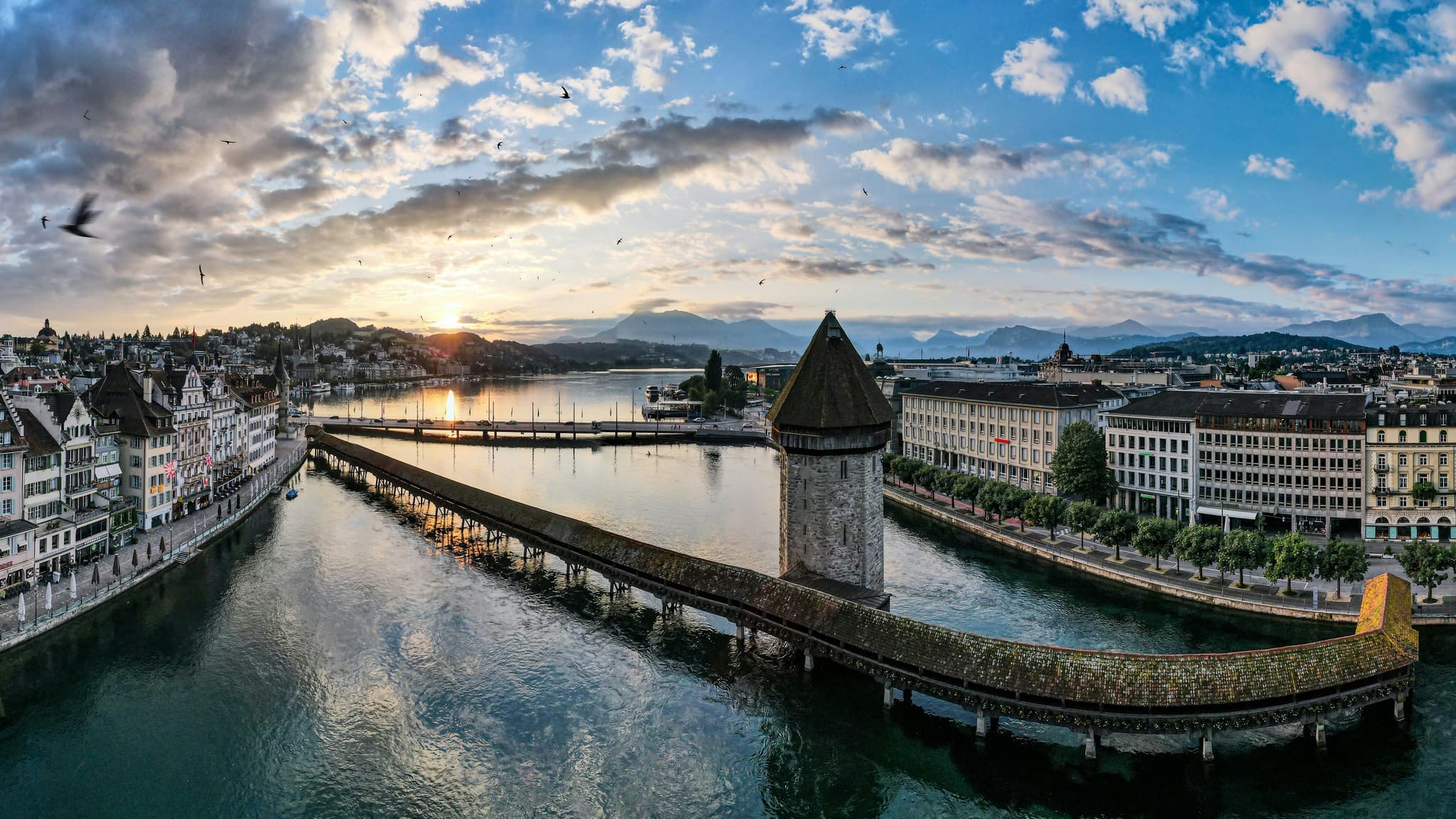 Chapel Bridge and its tower reflected in the Reuss River in Lucerne