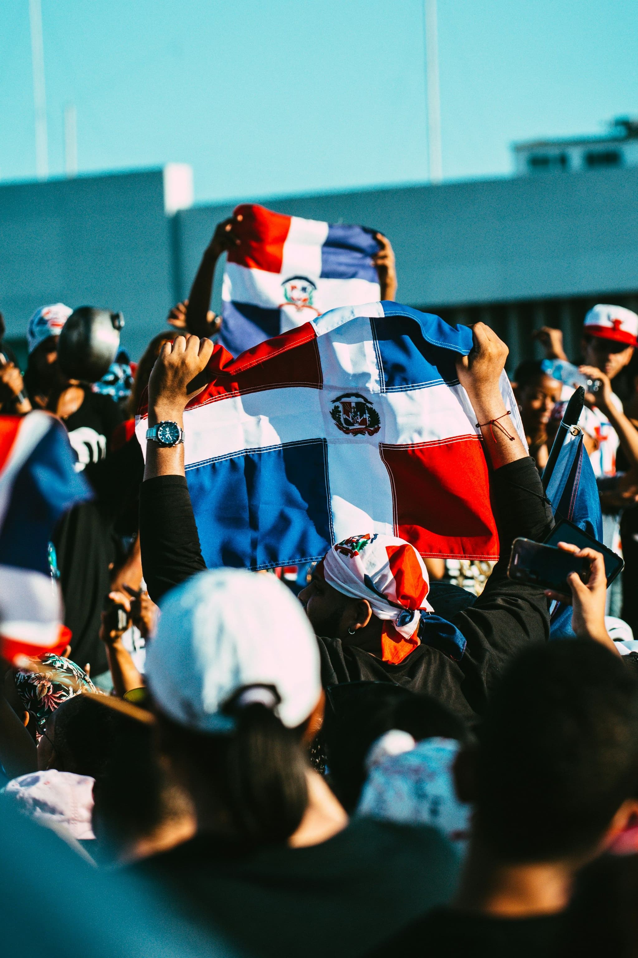 Fans in a baseball stadium waving a Dominican flag
