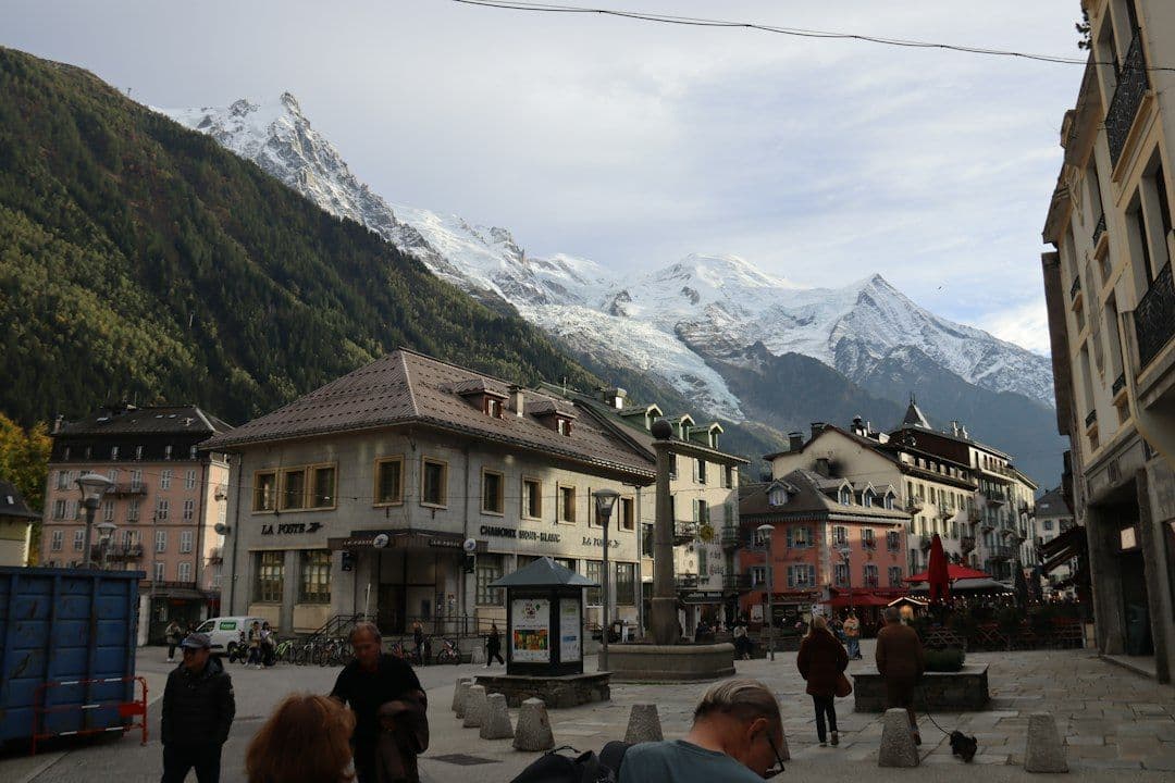 A snowy ski-resort town square with mountains rising behind it.
