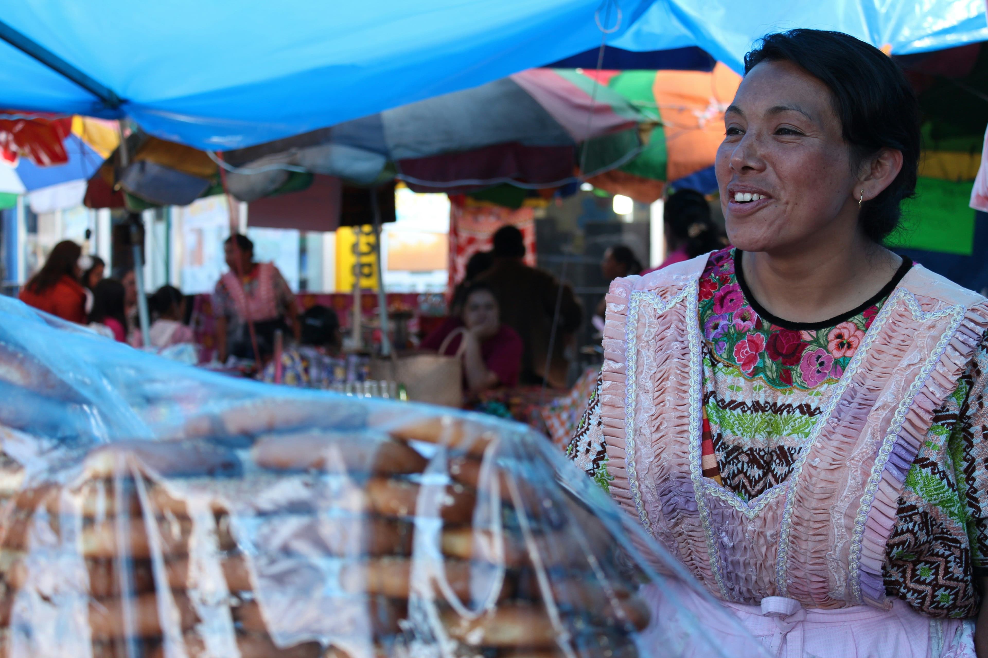 Woman selling bread at a local market in Guatemala