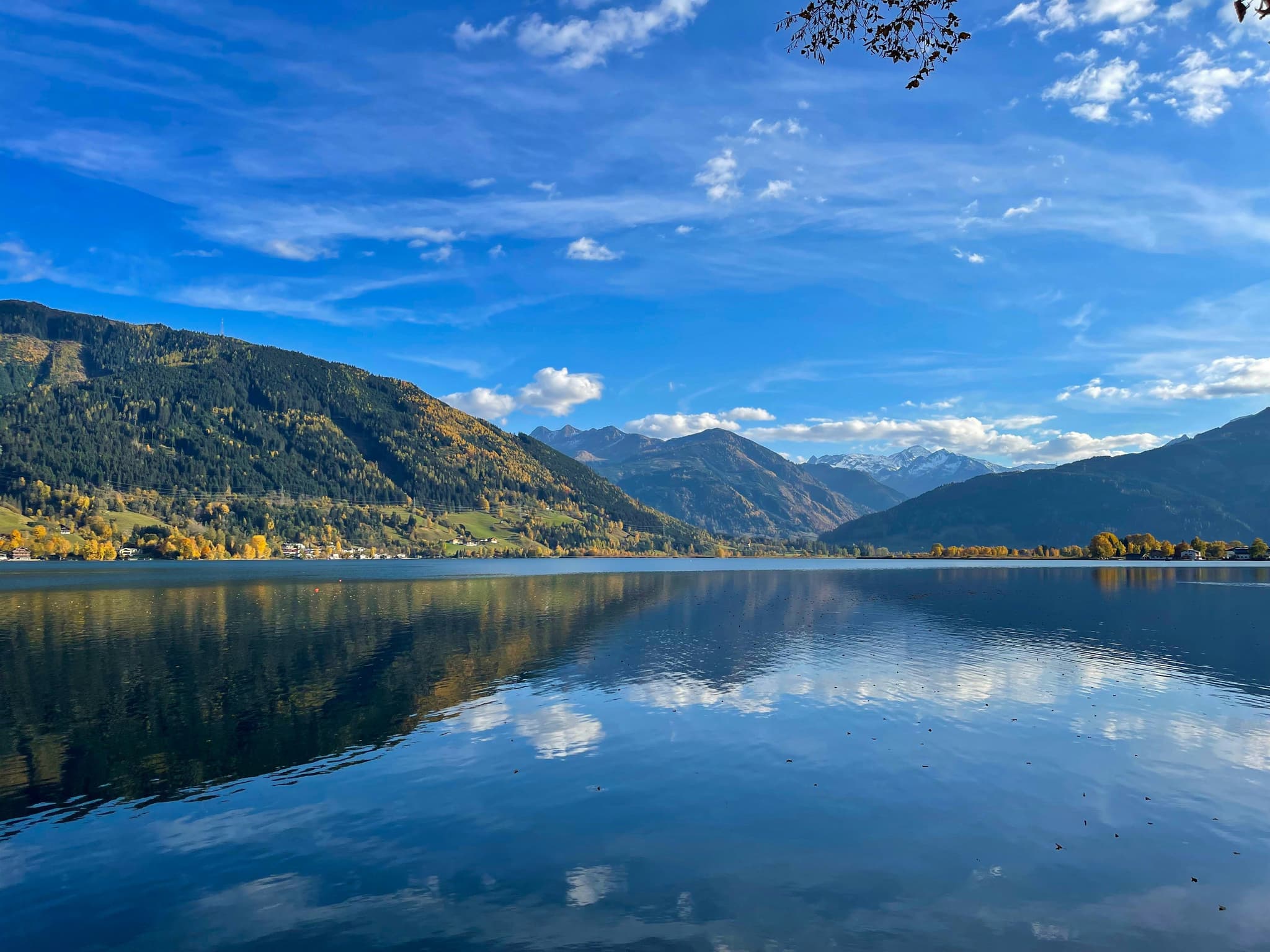 Summer lake with mountains in the background and clear blue sky