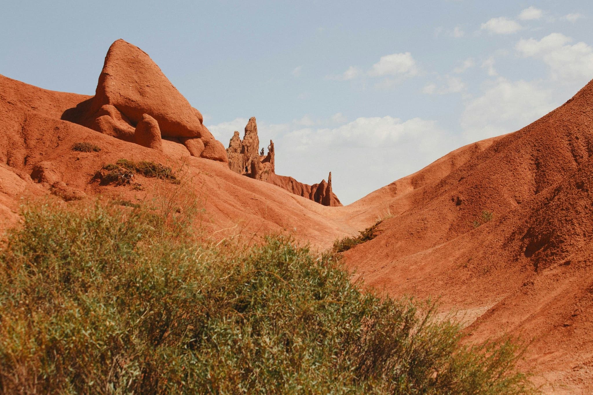 Eroded red rock formations under a blue sky