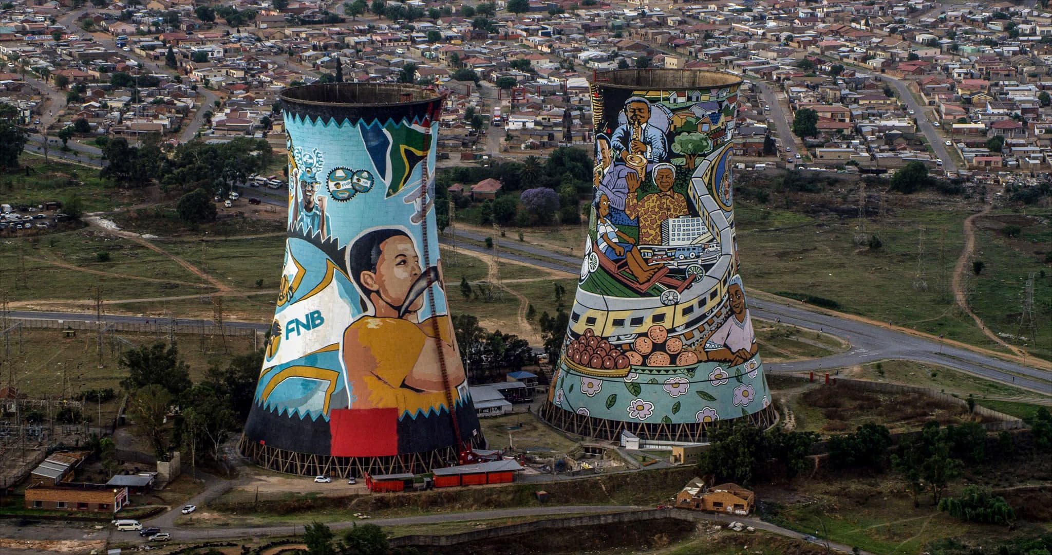 two painted high towers from above in central soweto surrounded by city houses