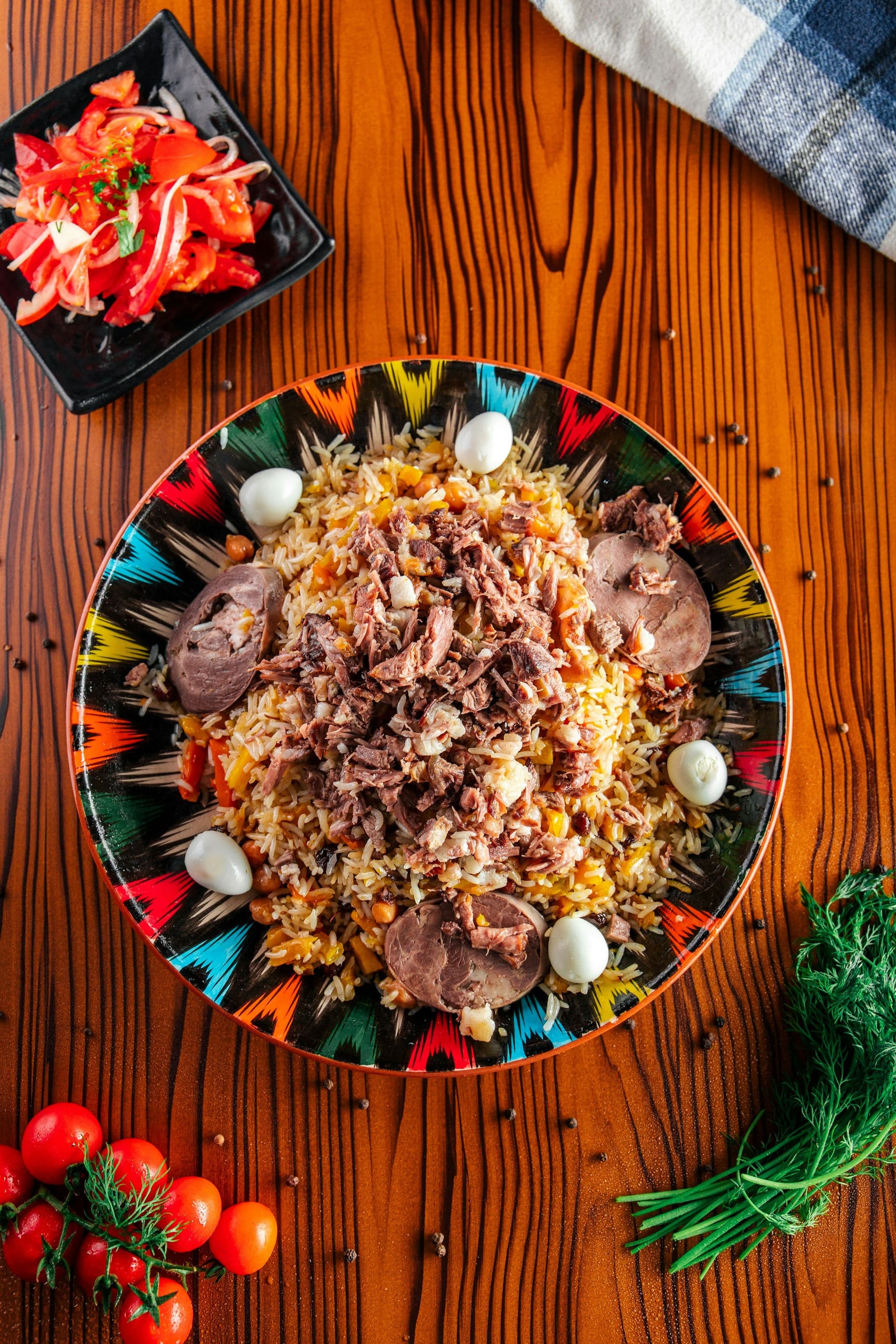 A plate of plov with rice, meat and carrots