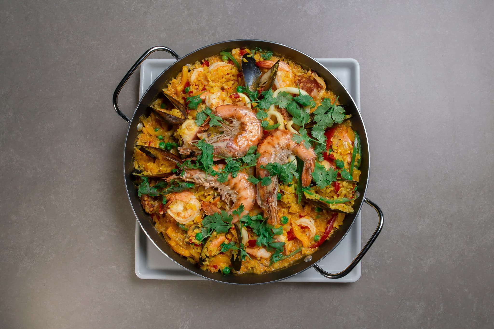A round pan with paella with shrimp
