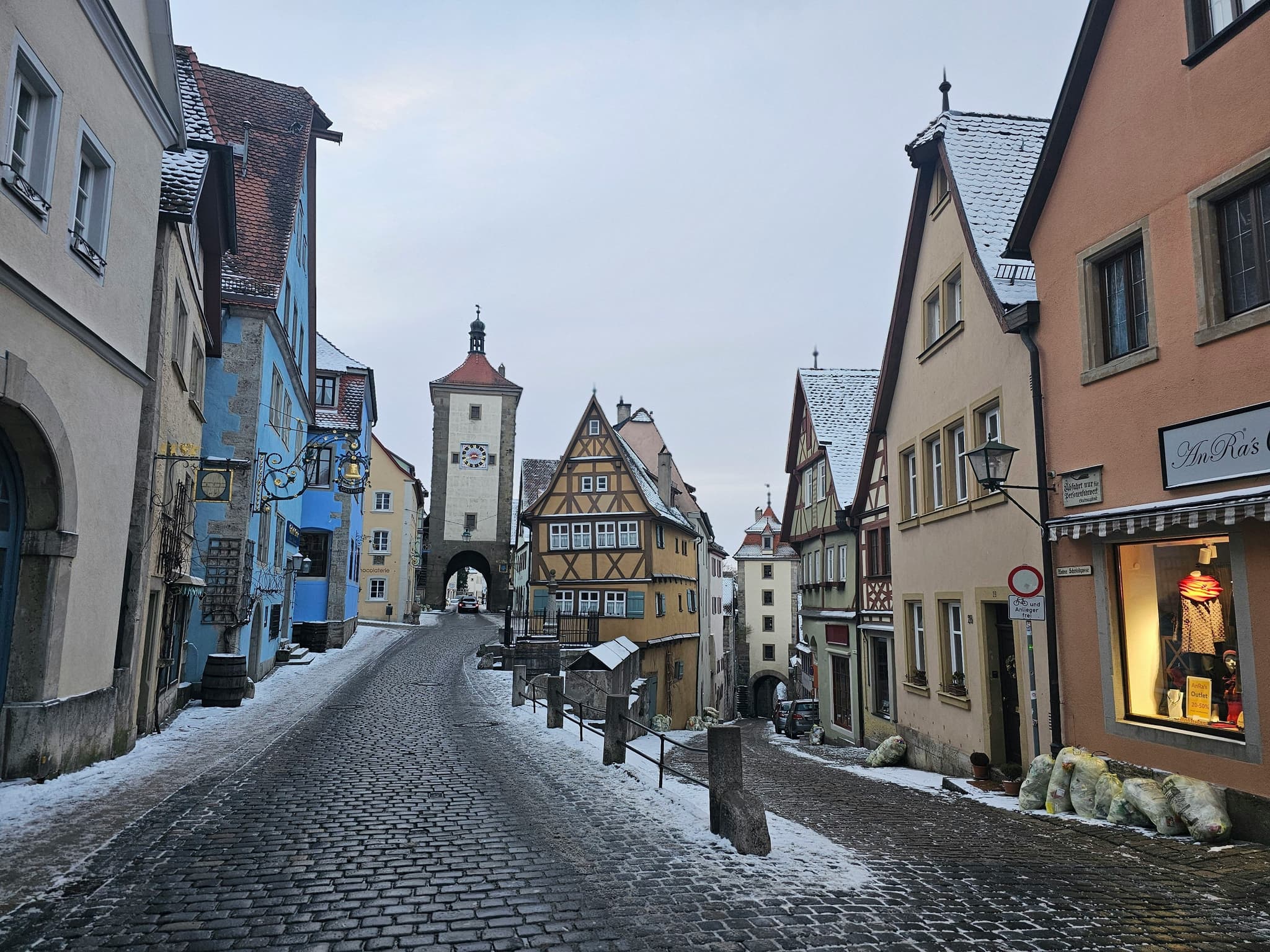 A cobblestone street and clock tower in Rothenburg ob der Tauber, Germany