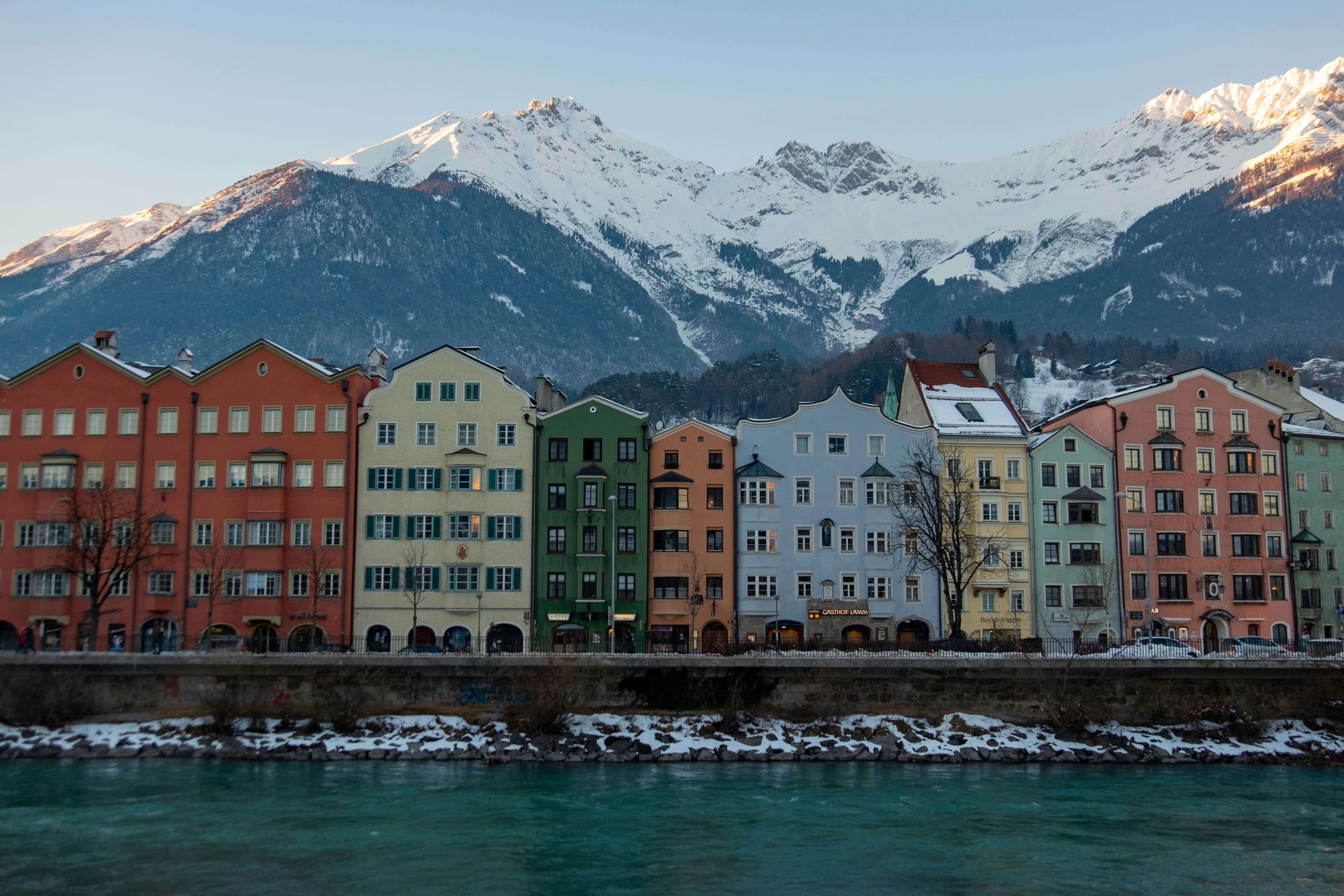 Colorful houses of Innsbruck in front of a snow mountain