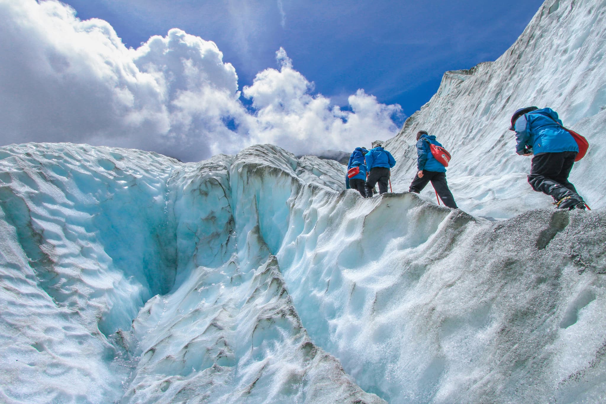 Glacier hiking in Iceland three people hiking through the snow