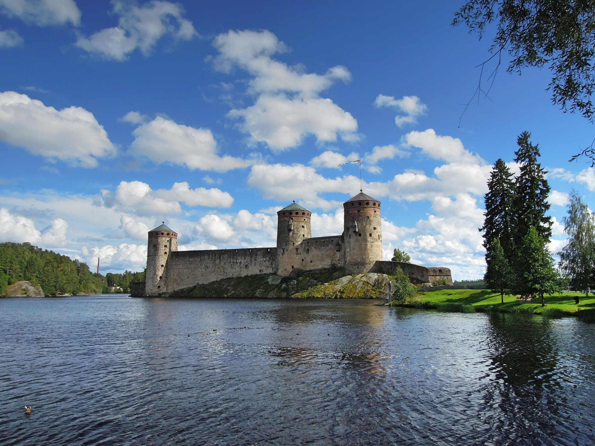 Olavinlinna Castle in Savonlinna sitting by the lake on a good weather day