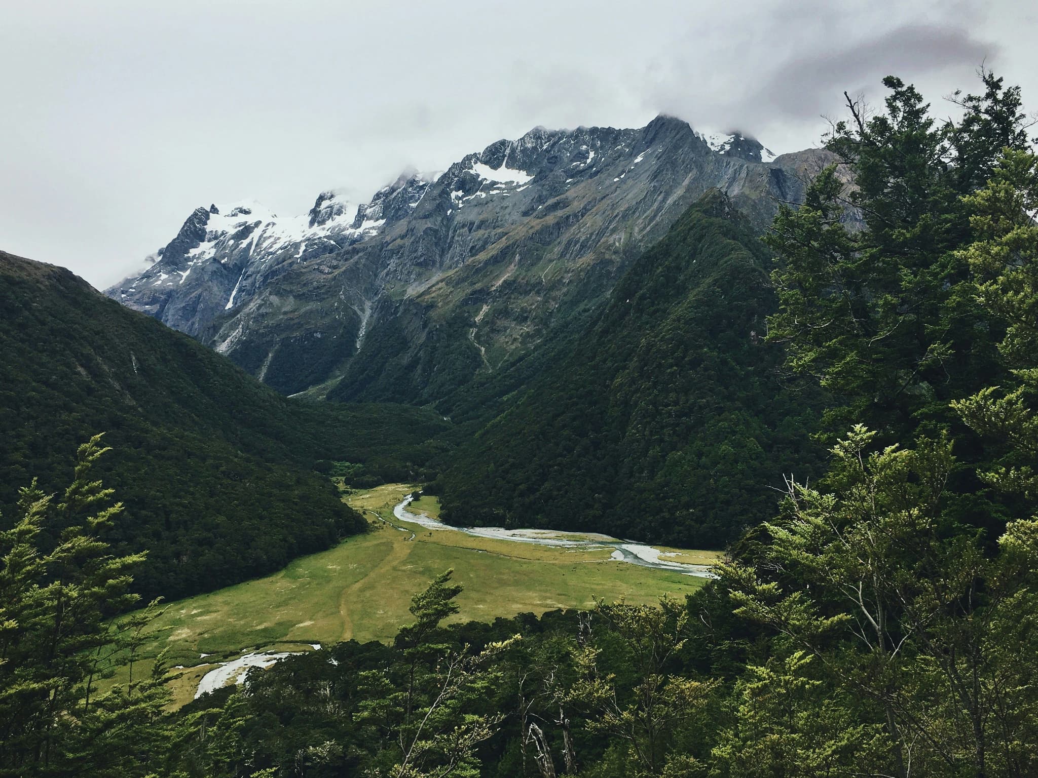 Routeburn Track high mountains and green pine trees