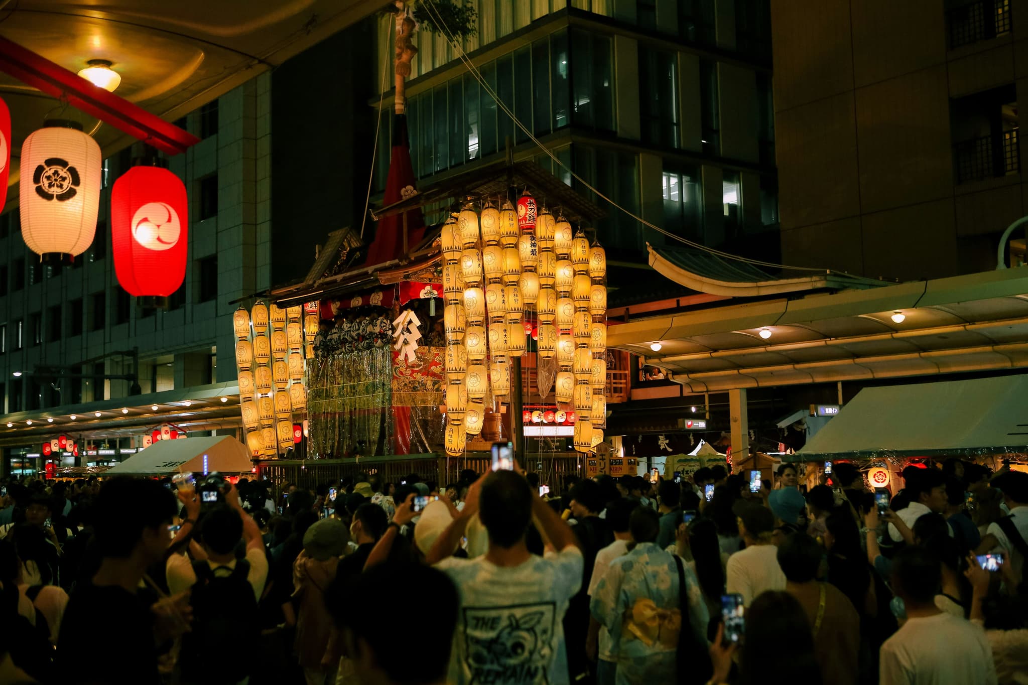 Lanterns lit and crowds gathered in japan for Gion Matsuri