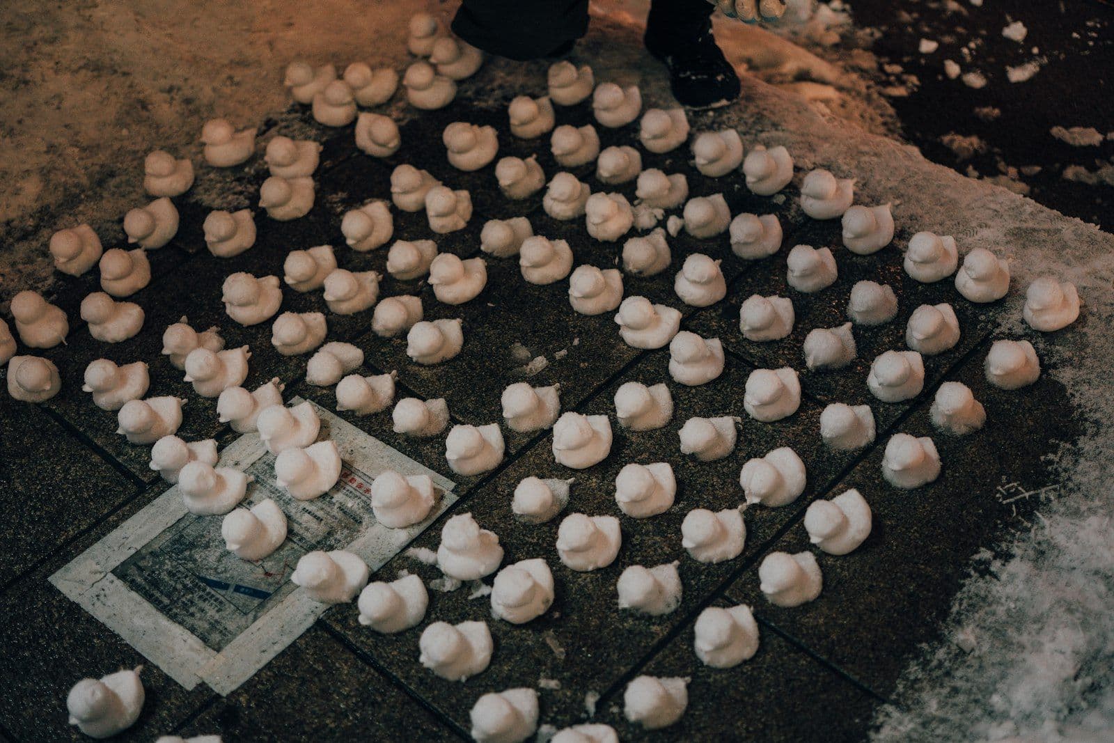 Rows of small snow-sculpture ornaments on display at the Sapporo Snow Festival in Hokkaido, Japan, part of the festival's lighter, hands-on side.