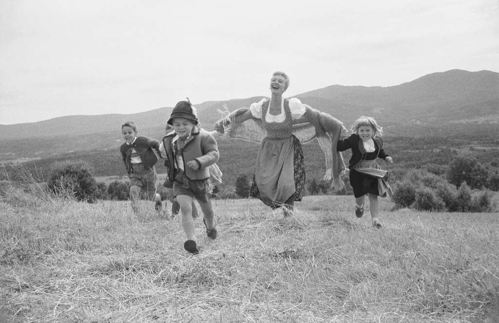Sound of music actors running in a field, black and white image