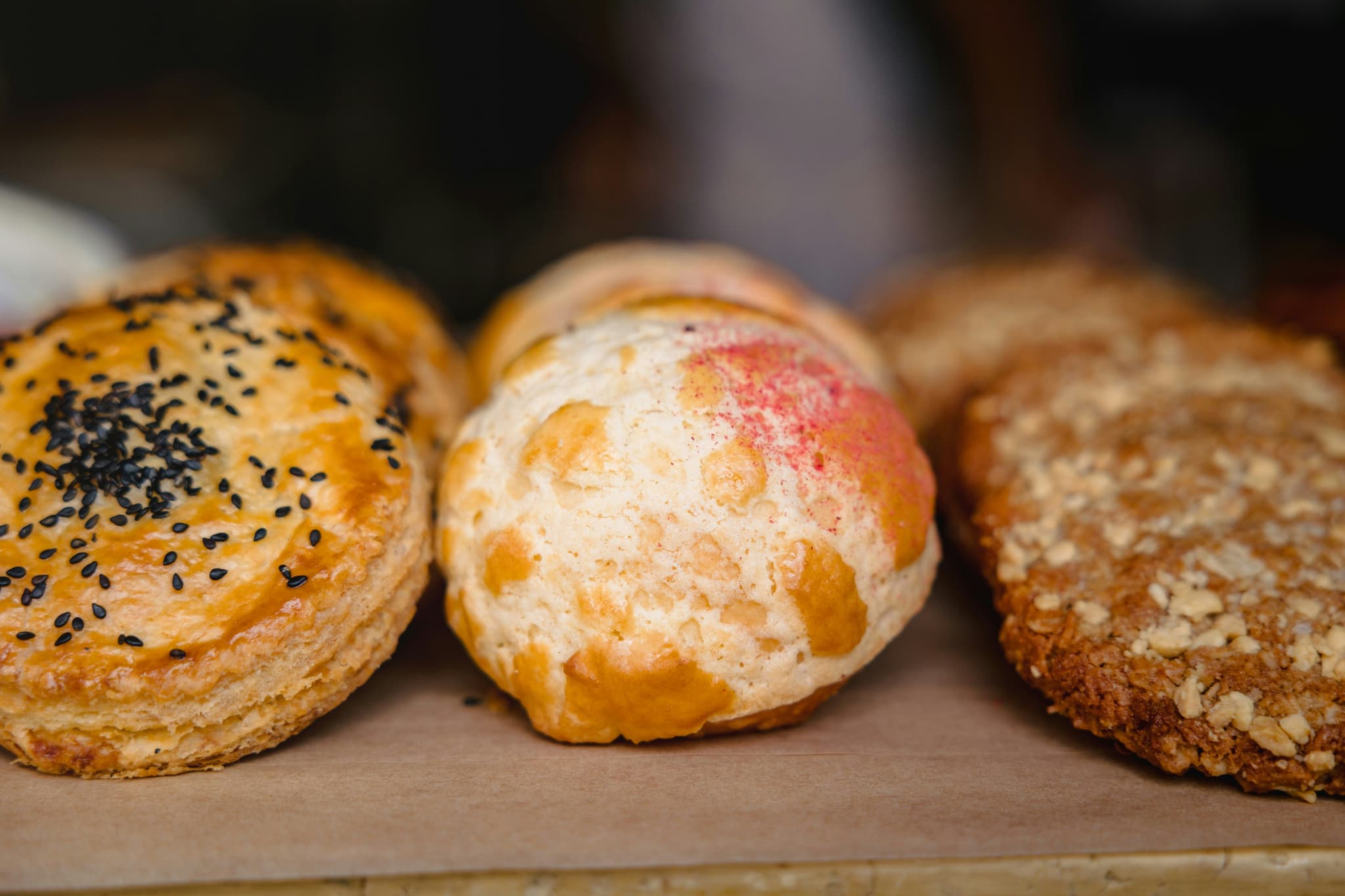 Three pastries lined up in a pastry store up close