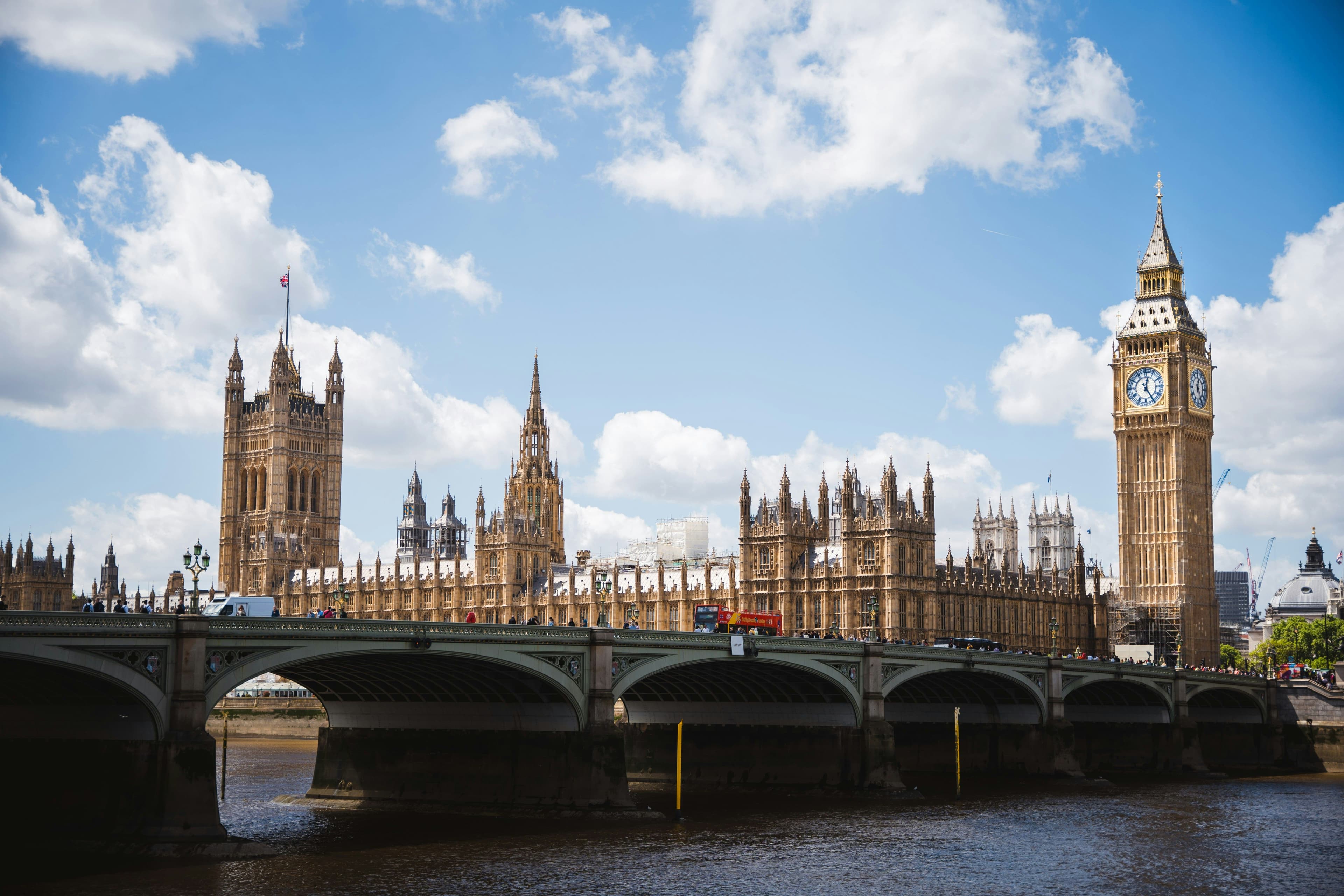 Big ben and bridge in England on a sunny day with clouds in the sky