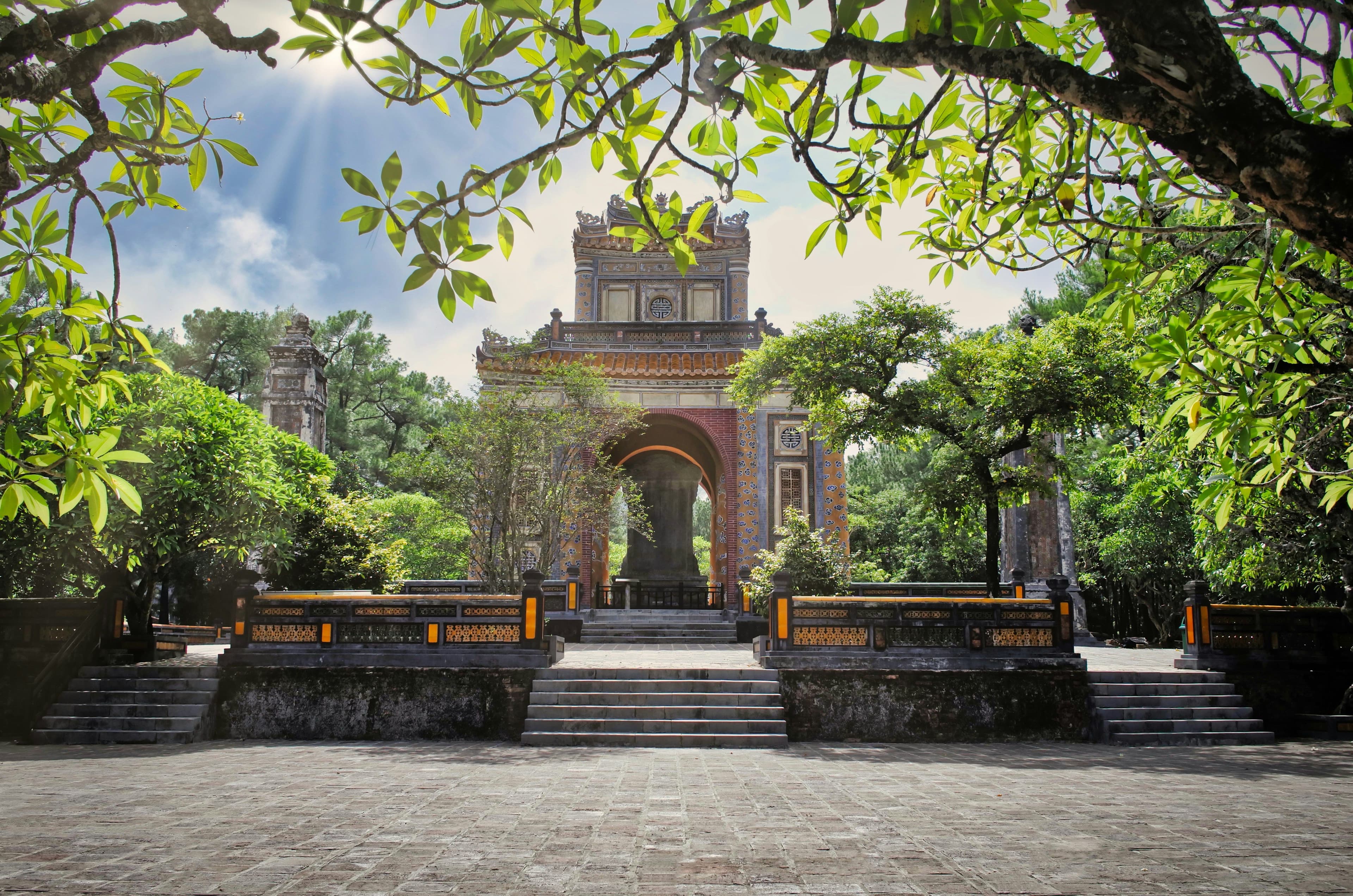 Temple in hue vietnam with a tree and stairs