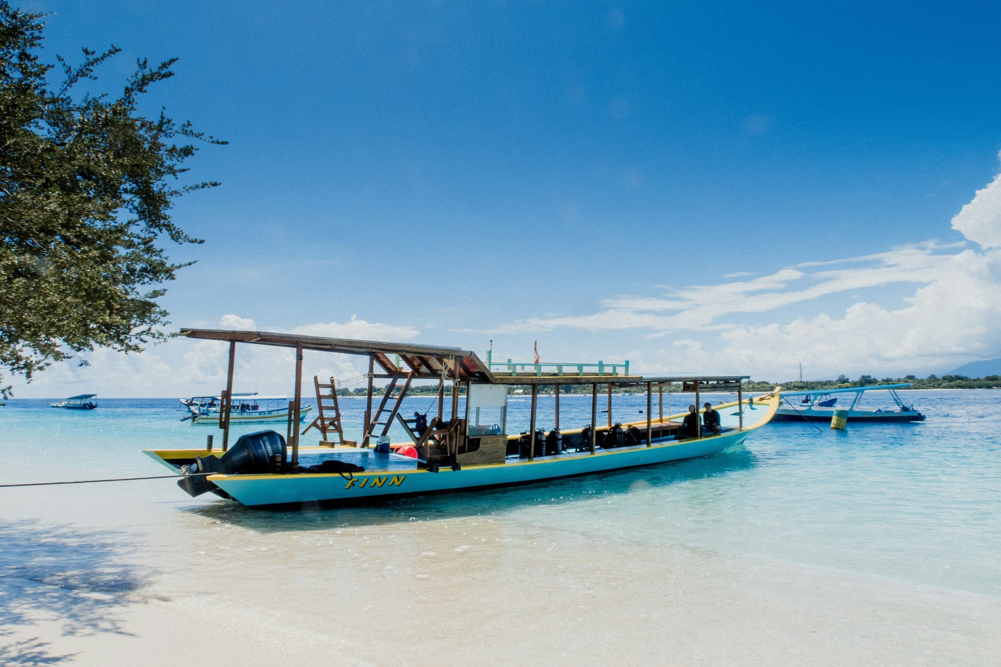 Boat in the low water in Gili Islands turqoise sea and blue sky
