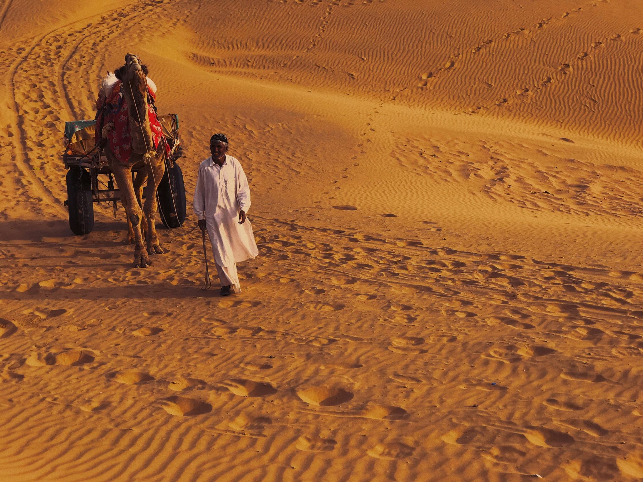 Walking across the Thar Desert near Jaisalmer, Rajasthan, at golden hour.