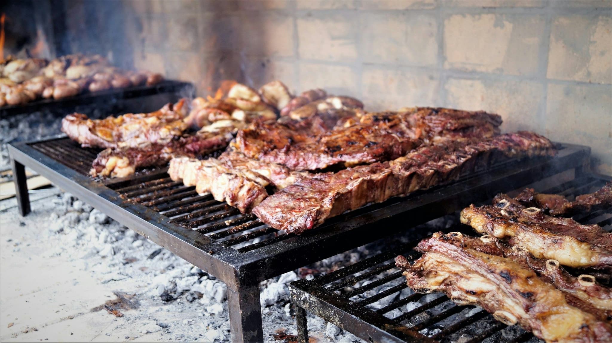 Beef cooking on an asado grill in Mendoza