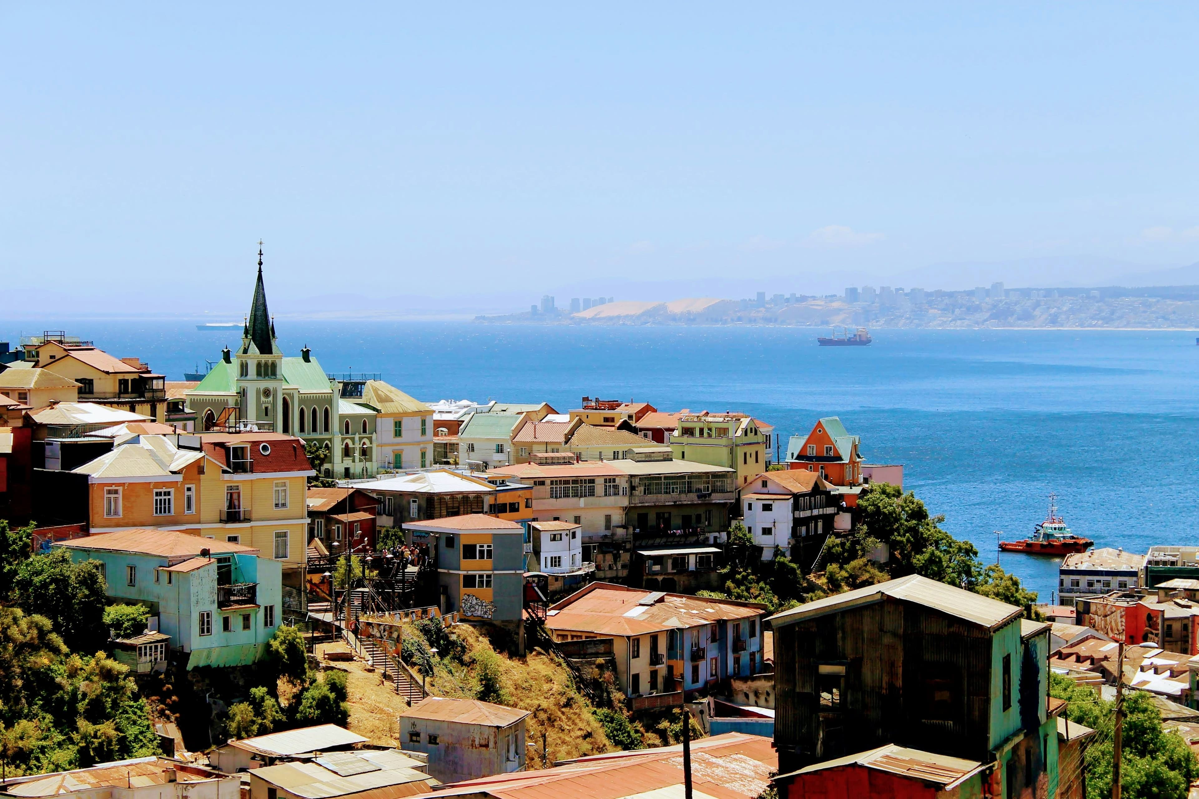 Colorful houses on a hill in Valparaíso with the waterfront on the right