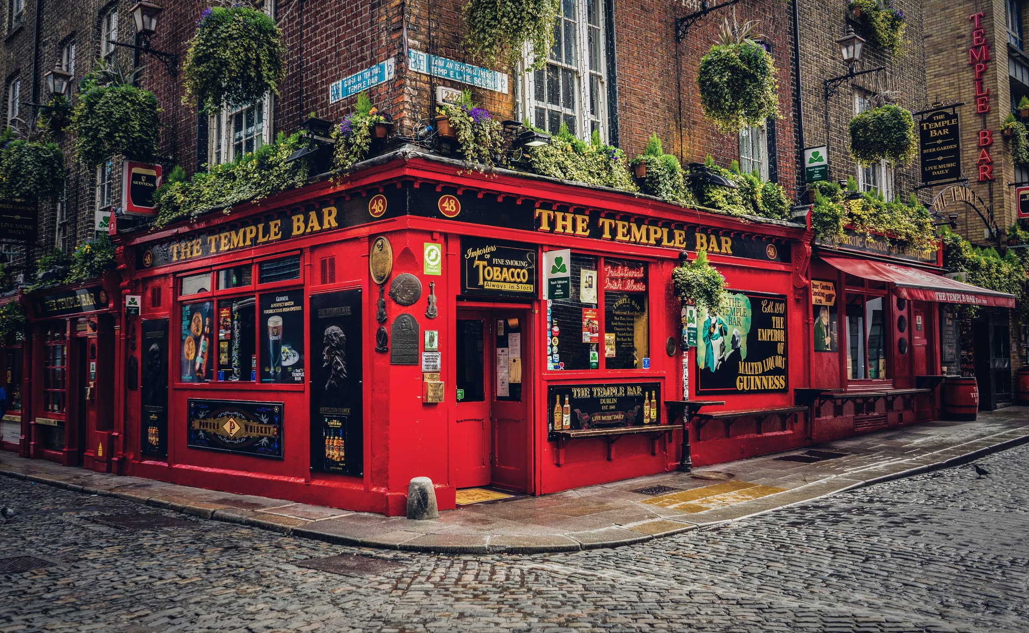Red bar called Temple Bar on a corner of a street in dublin