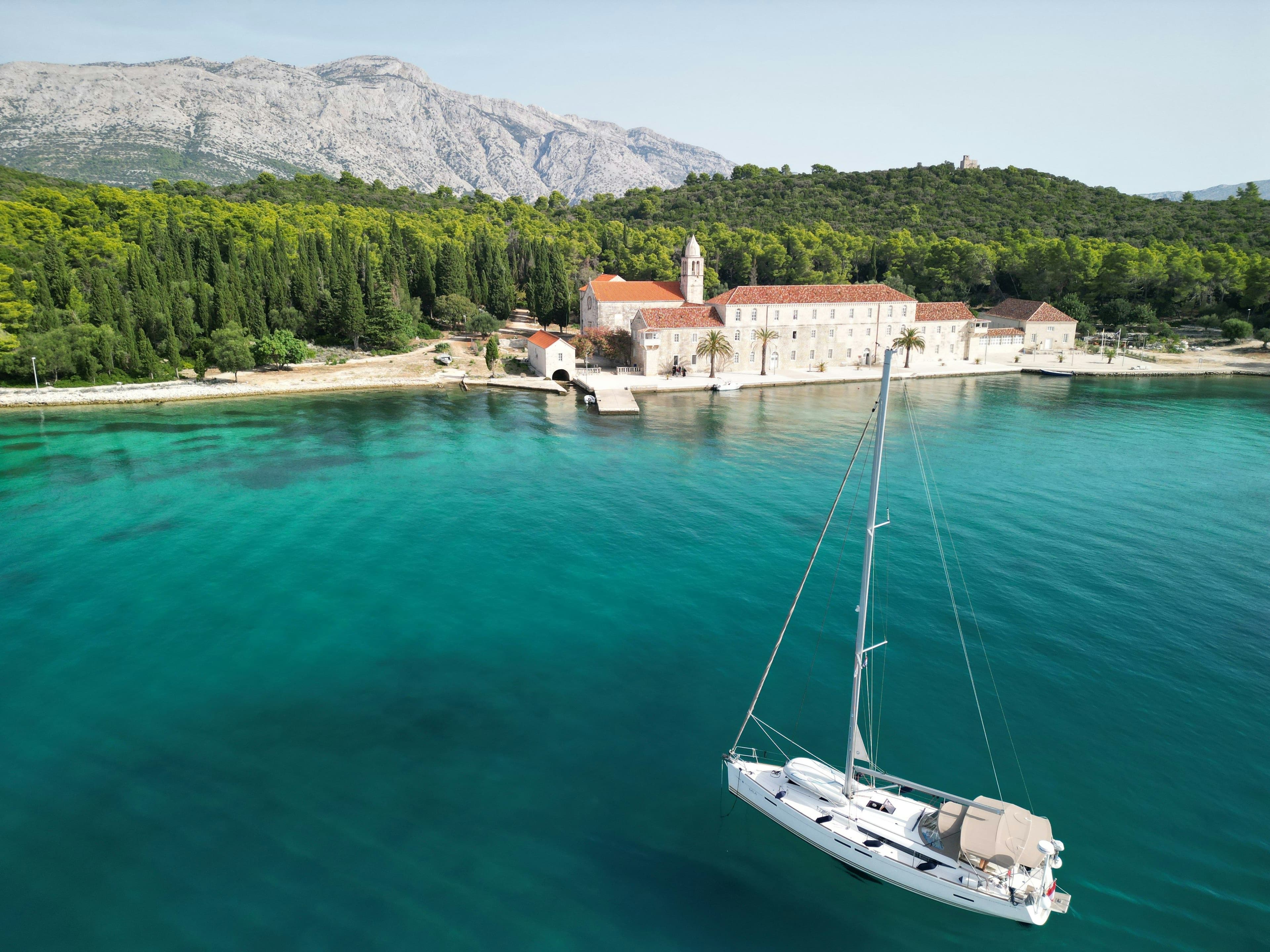 boat arriving at an old town in Croatia