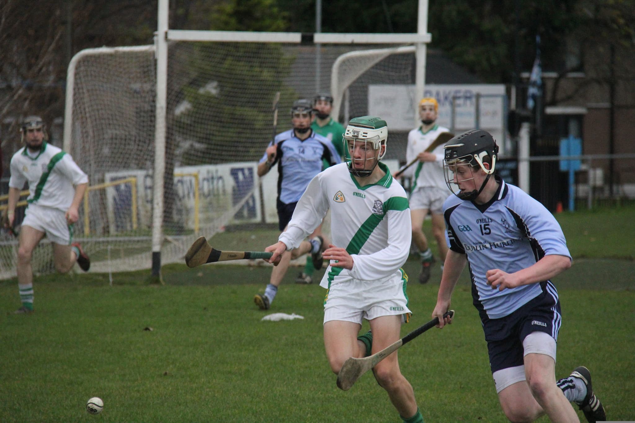 Two men running during a GAA hurling match in Ireland