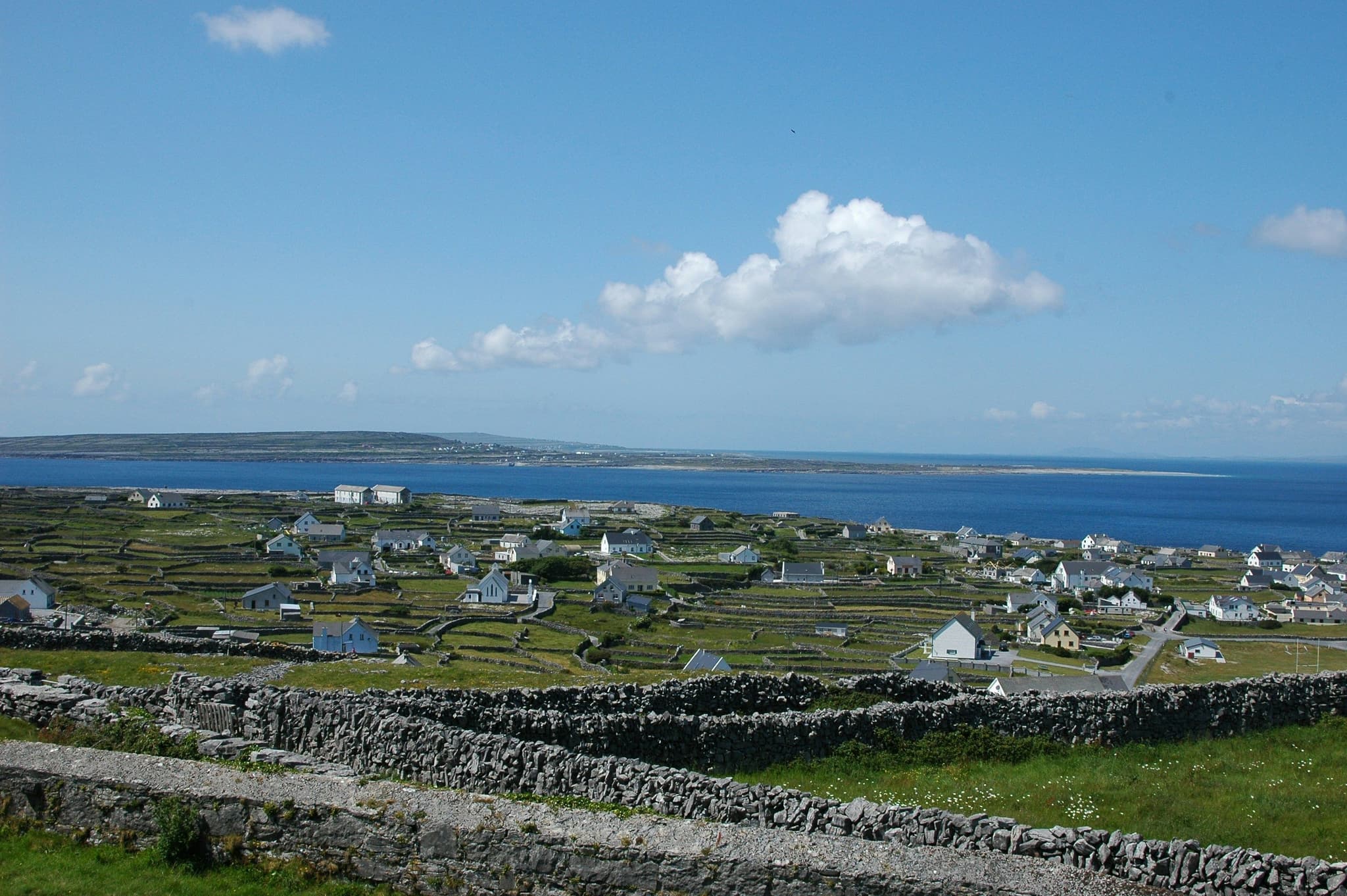 Small houses on green grass near the sea of Aran Islands