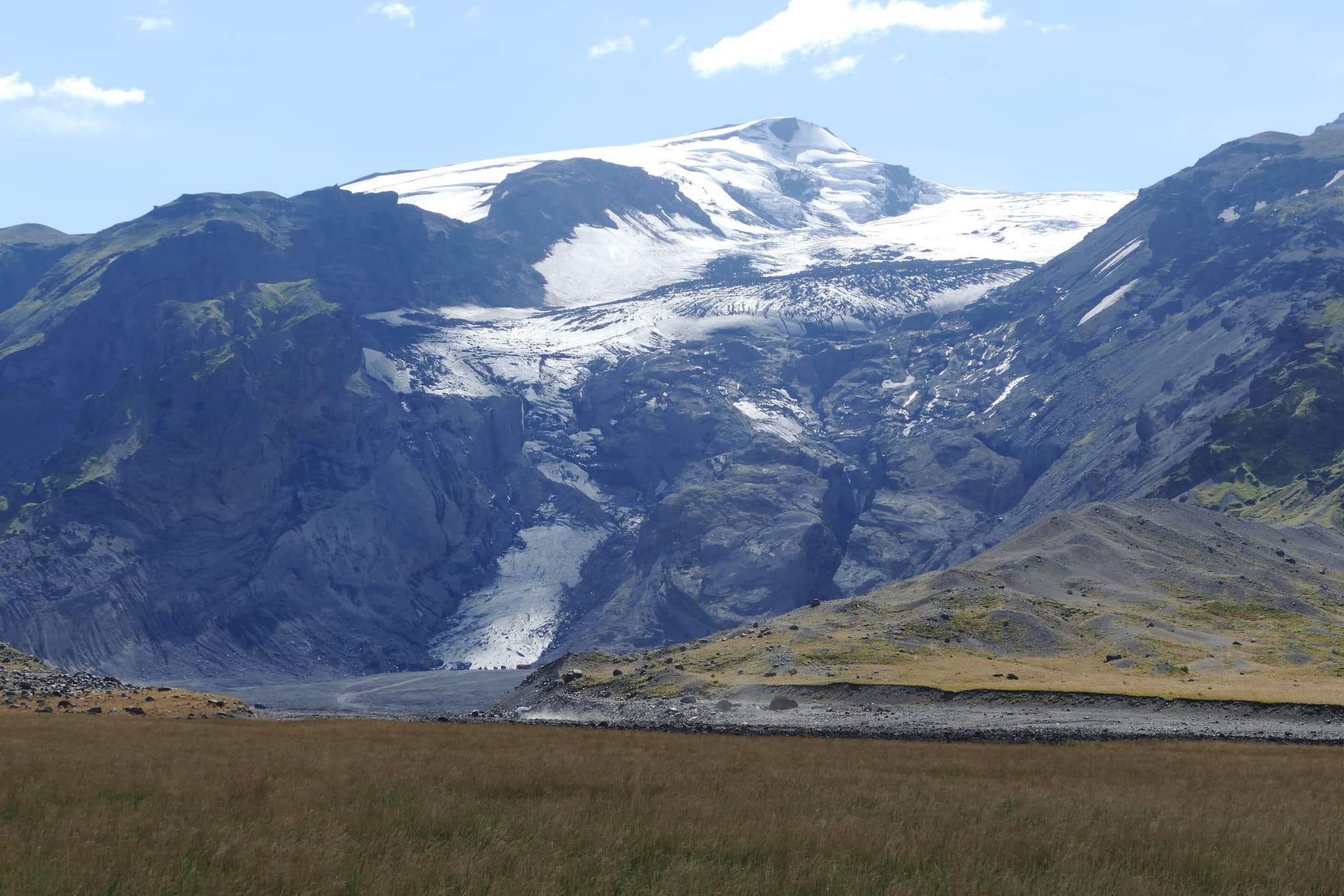 Eyjafjallajokull mountain with snow surrounded by yellow grass