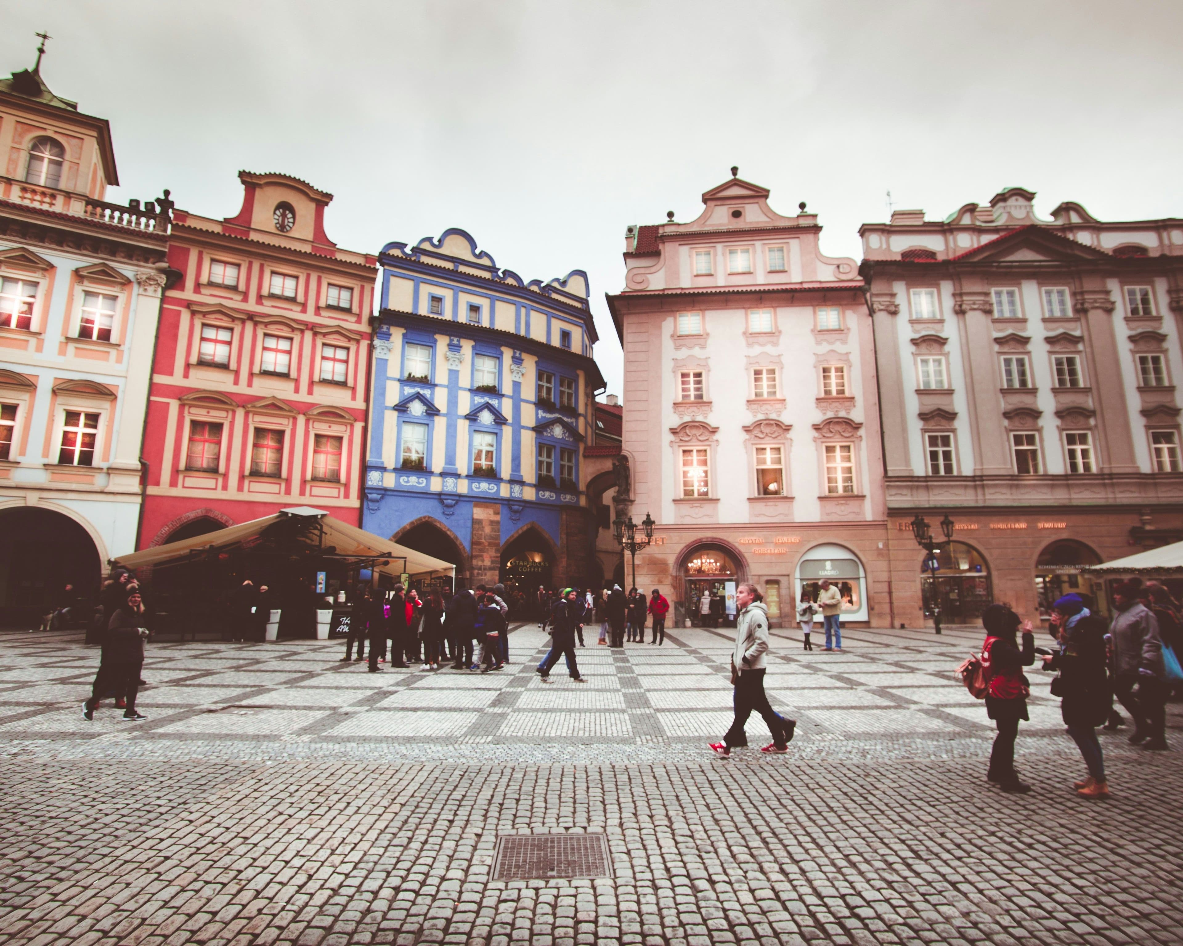 Picture of colorful buildings in the old town of Prague, people walking