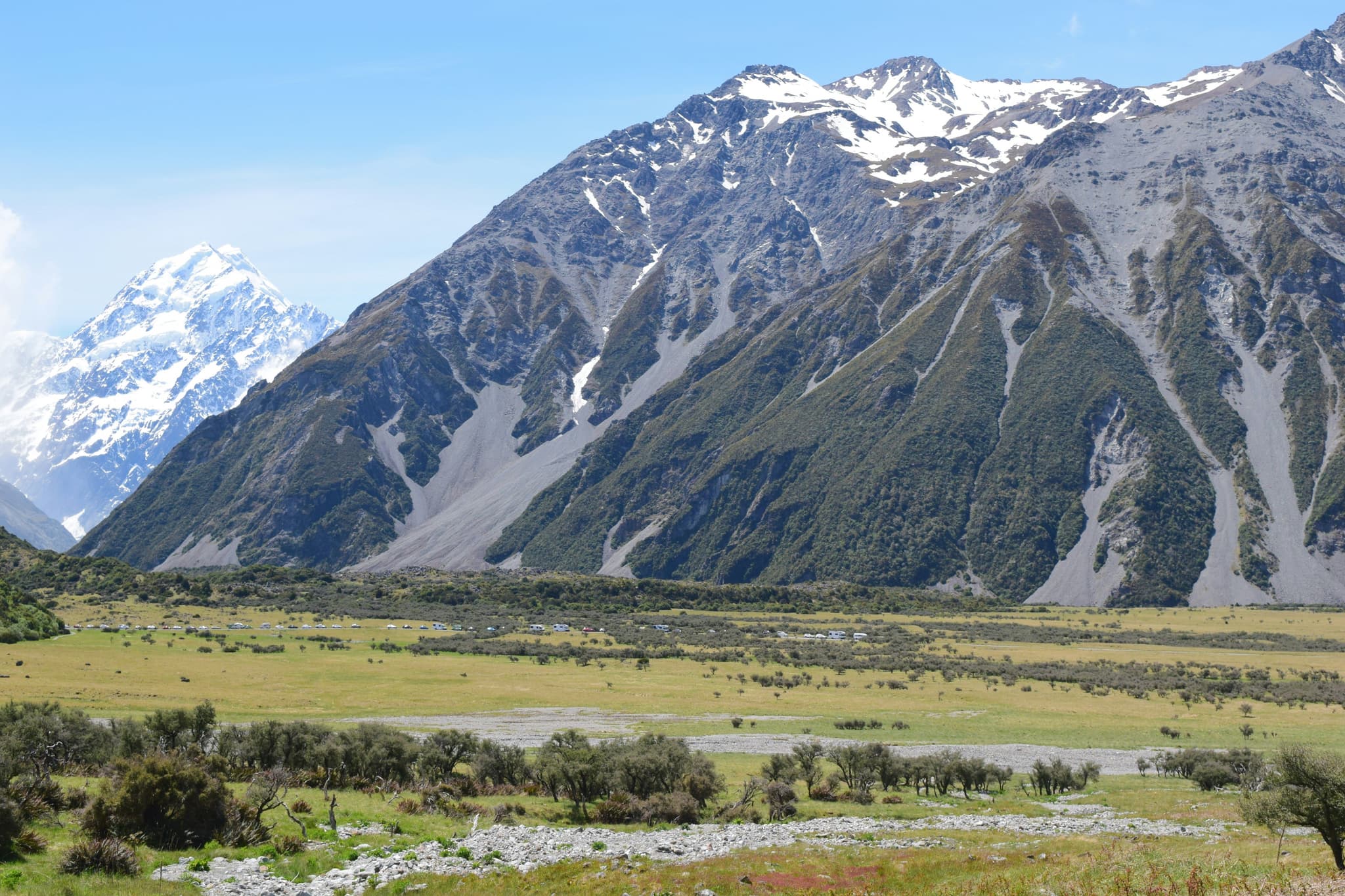 green grass and snowy mountains in Hooker Valley