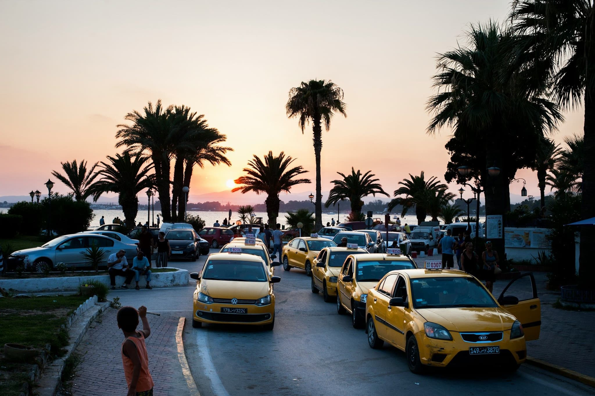 Yellow taxis parked in a line at sunset