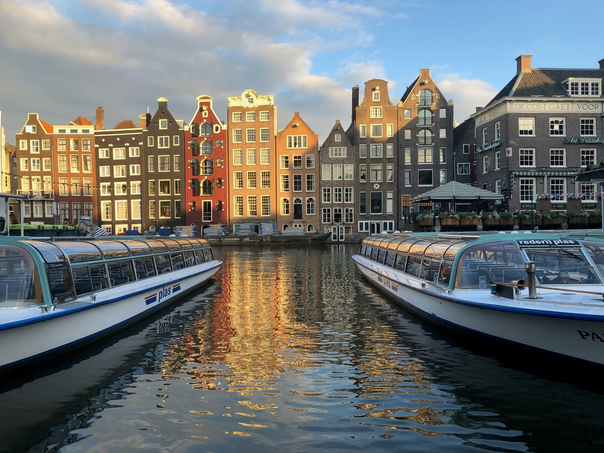 Boats ready in the water for canal cruise in Amsterdam