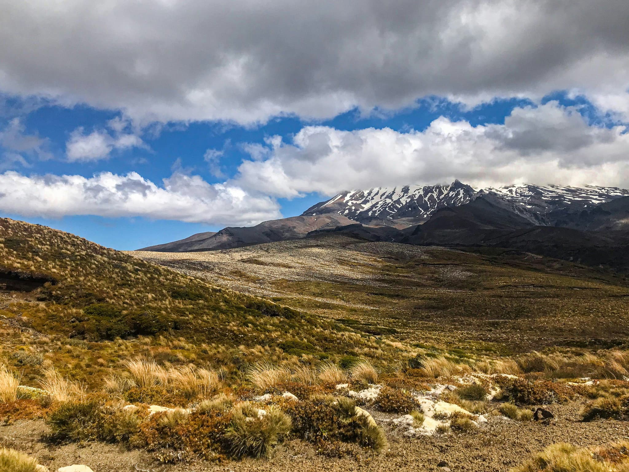 Landscape with hills and snow covered mountains in Tongariro National Park New Zealand