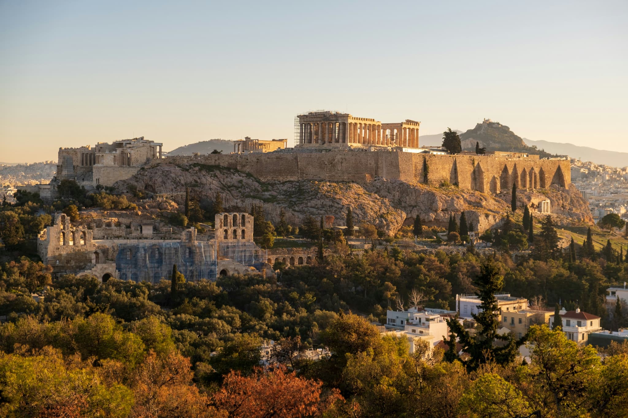 Aerial view of the entire region of athens ancient buildings with the Acropolis of Athens at sunset