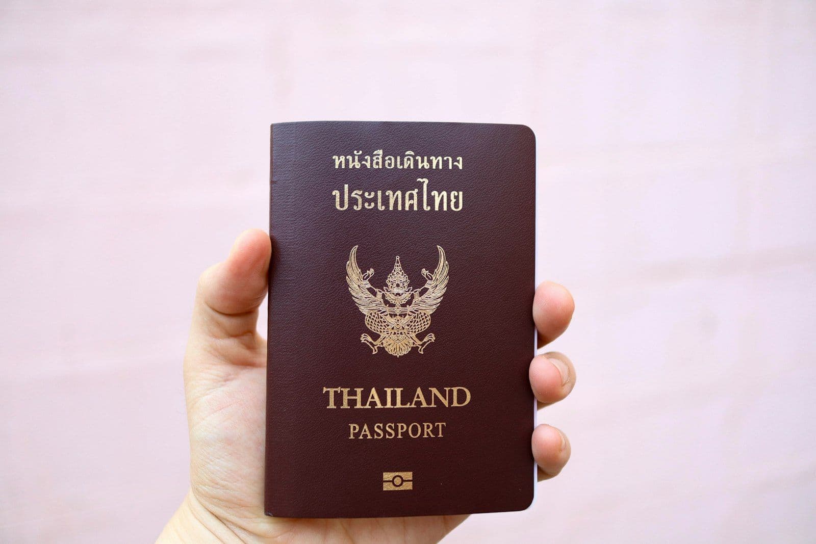 A person holding a Thai passport