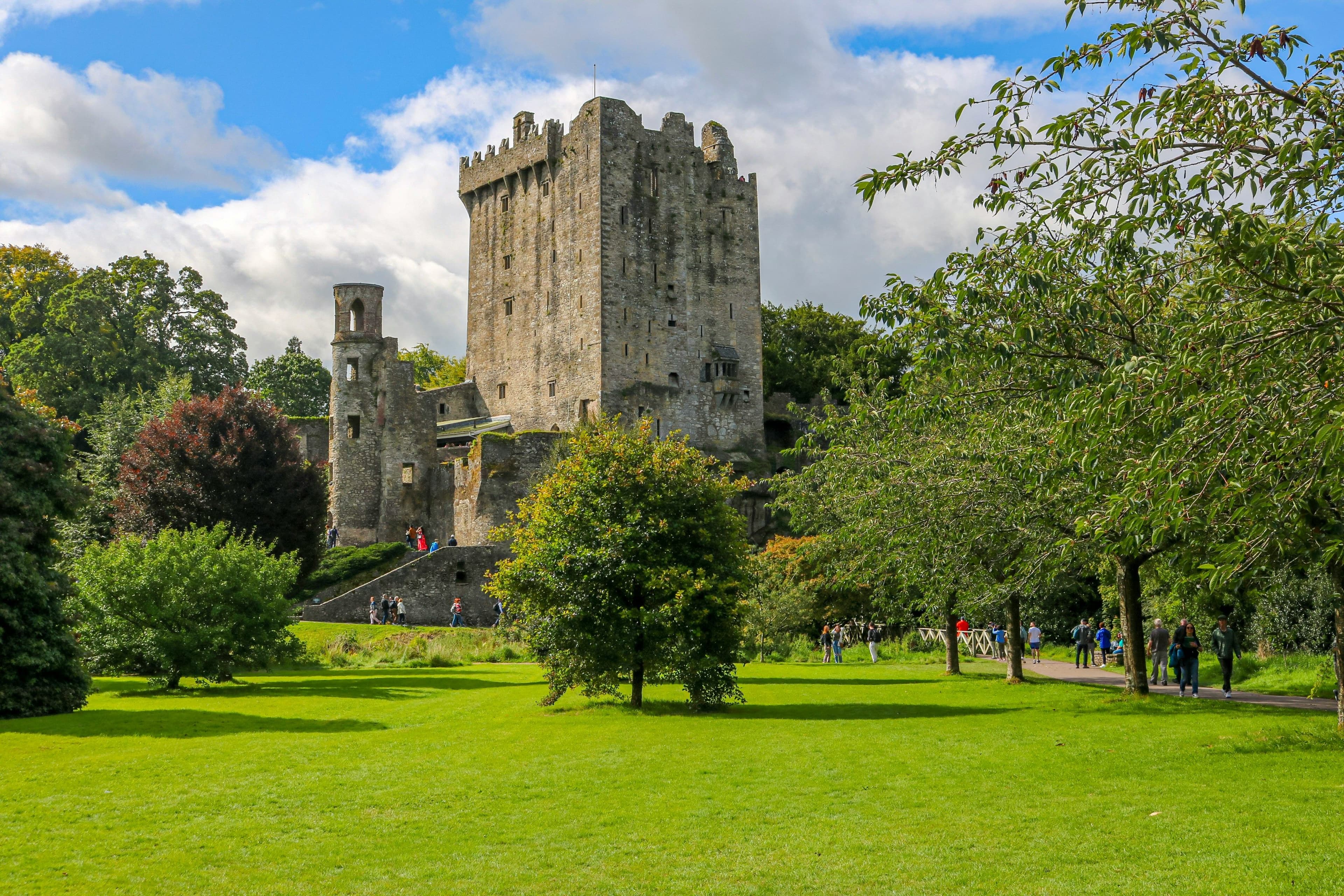 Blarney Castle surrounded by green grass without people but with trees