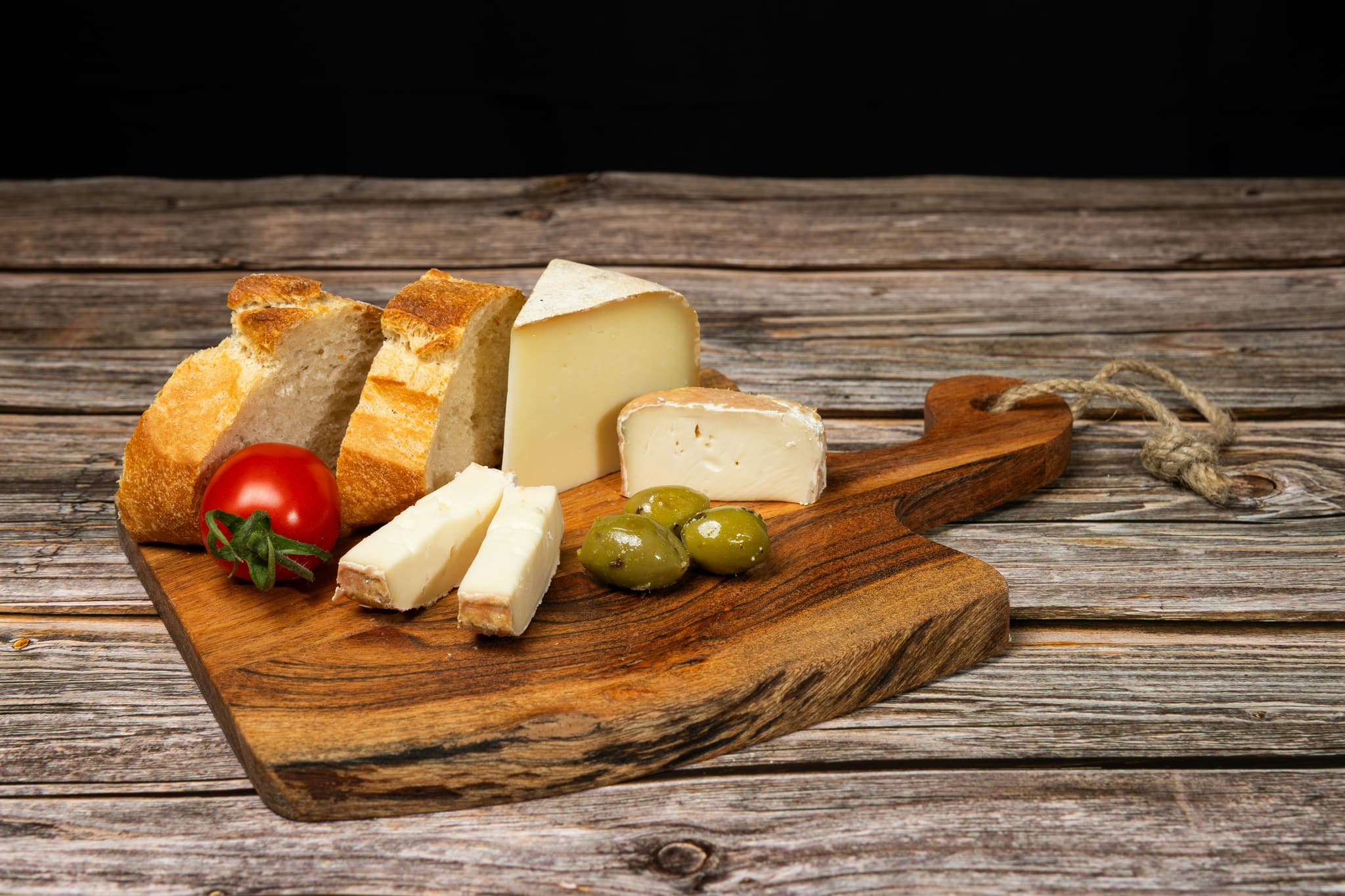 French cheese board with olives and tomato