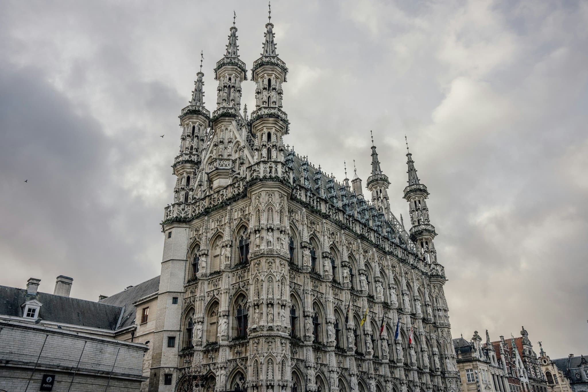 A Gothic town hall facade crowned with many slender spires