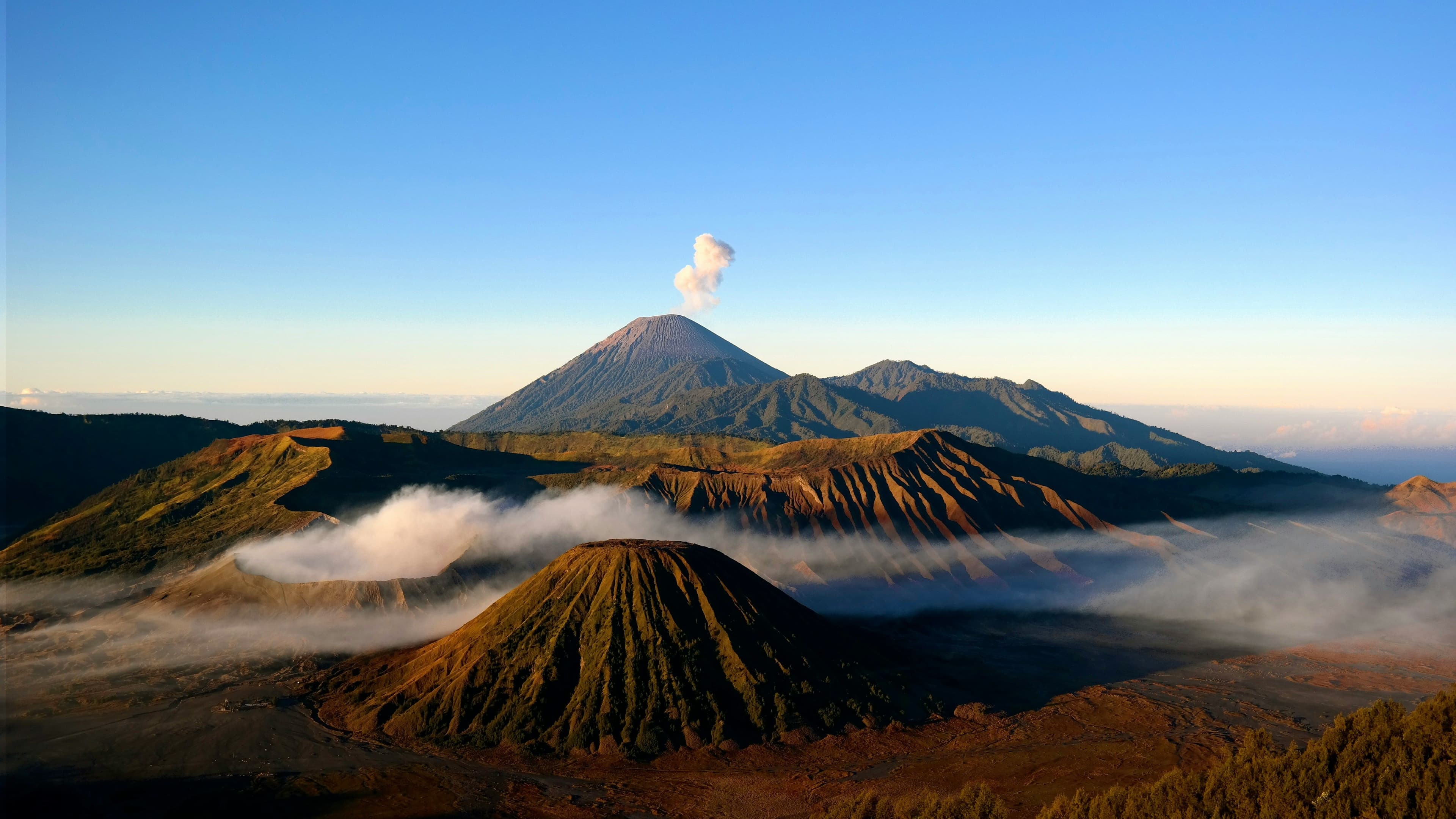 Sunrise at Mount Bromo with mist around the volcano