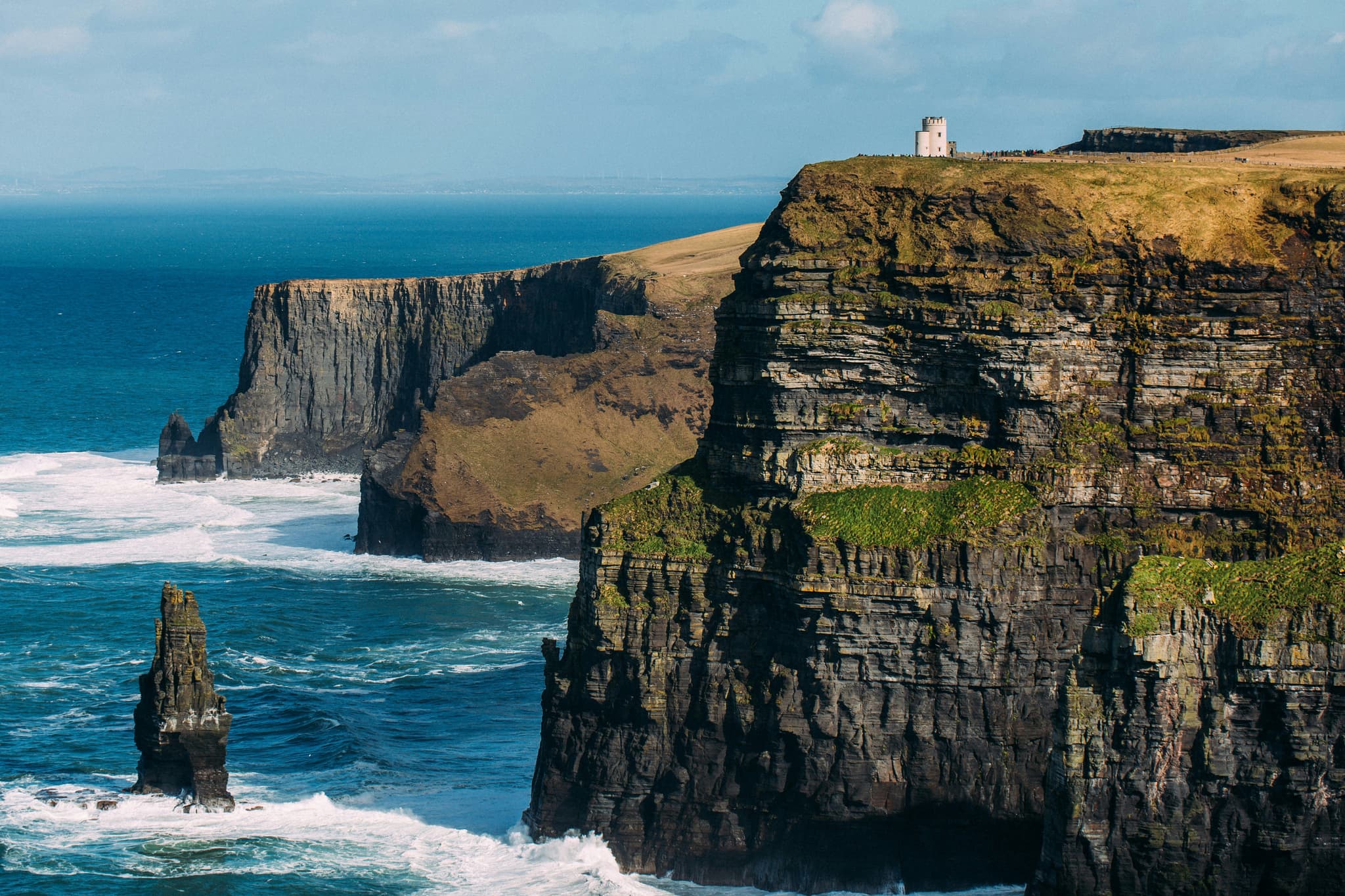 Huge Cliffs of Moher surrounded by the ocean
